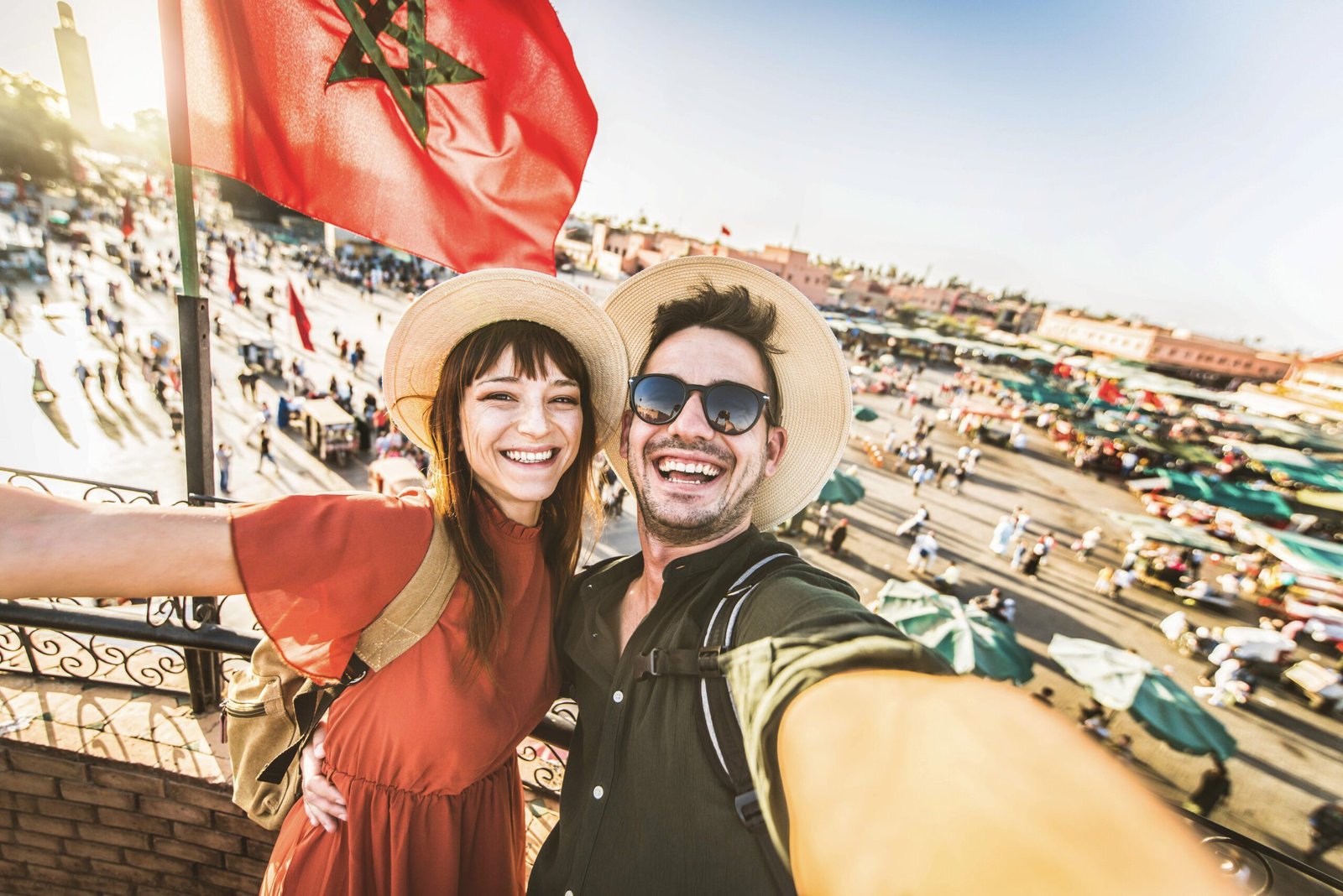 Happy tourists couple visiting Jamaa el-Fna market Marrakech, Morocco